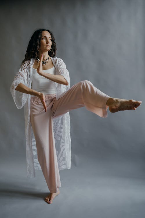 Woman Raising Her Leg While Meditating