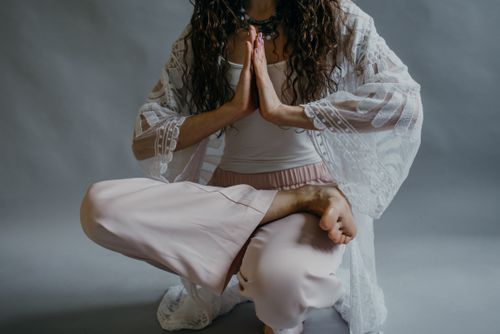Free A woman in yoga pose meditating indoors, focusing on relaxation and mindfulness. Stock Photo