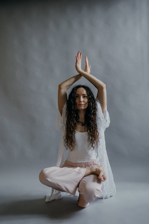 Woman in White Lace Top Doing Yoga