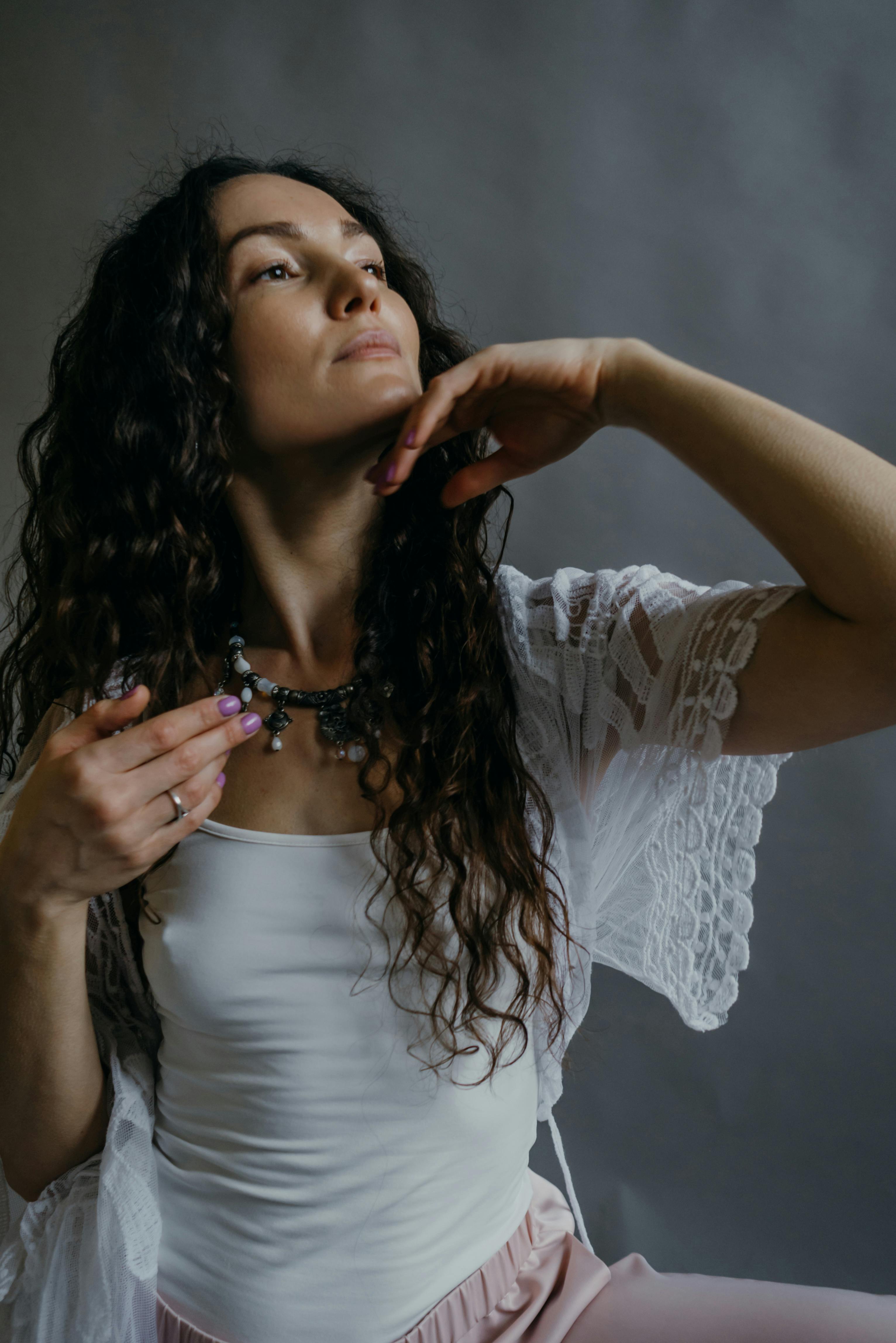 a woman posing with her hand on her chin