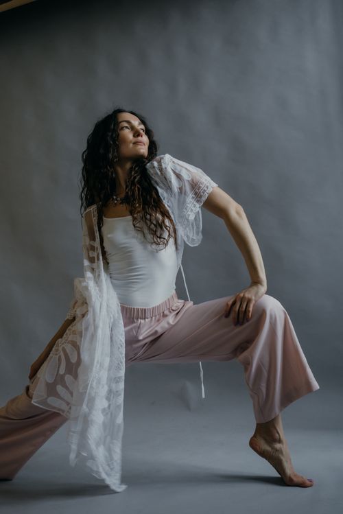 Free A fashionable woman posing barefoot in an elegant studio shoot. Stock Photo