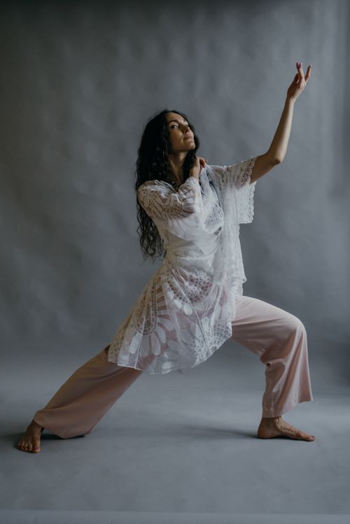 Free Artistic studio portrait of a stylish woman in a graceful pose, wearing a lace outfit. Stock Photo