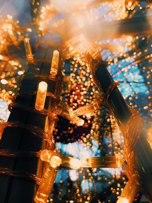 Free Close-up of glowing string lights creating a beautiful bokeh effect. Stock Photo