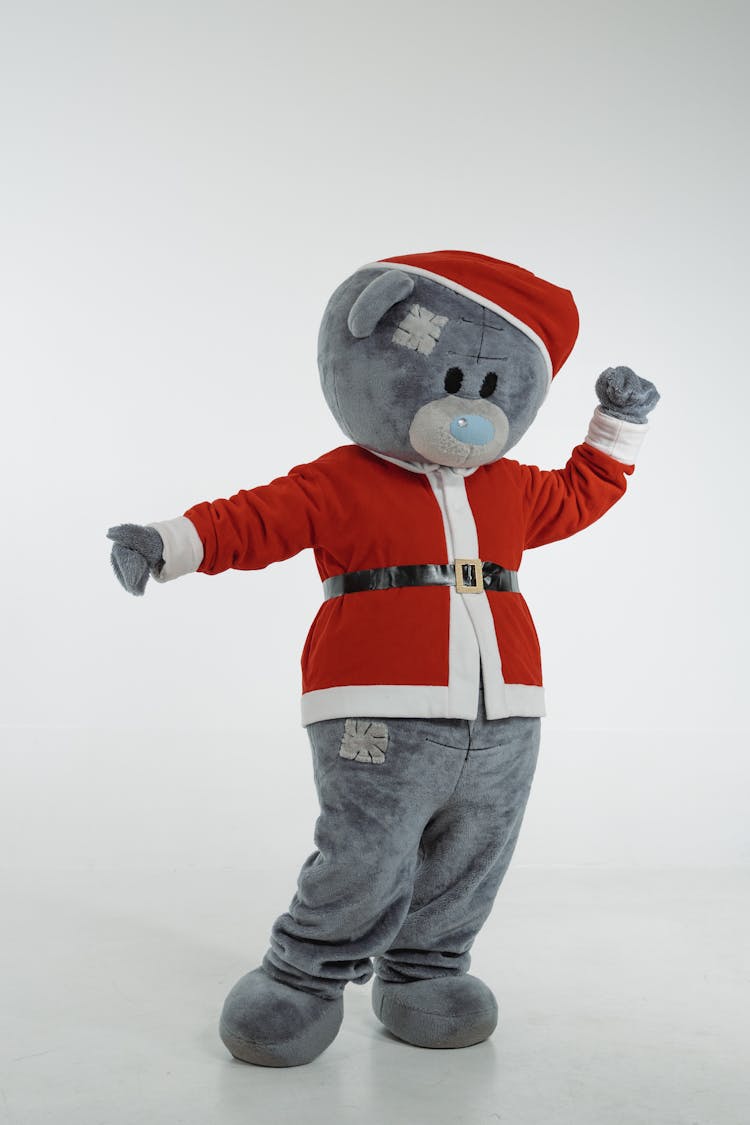 A Teddy Bear Mascot In Santa Claus Costume