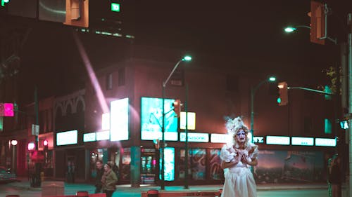 Person Wearing White Dress Near Traffic Light