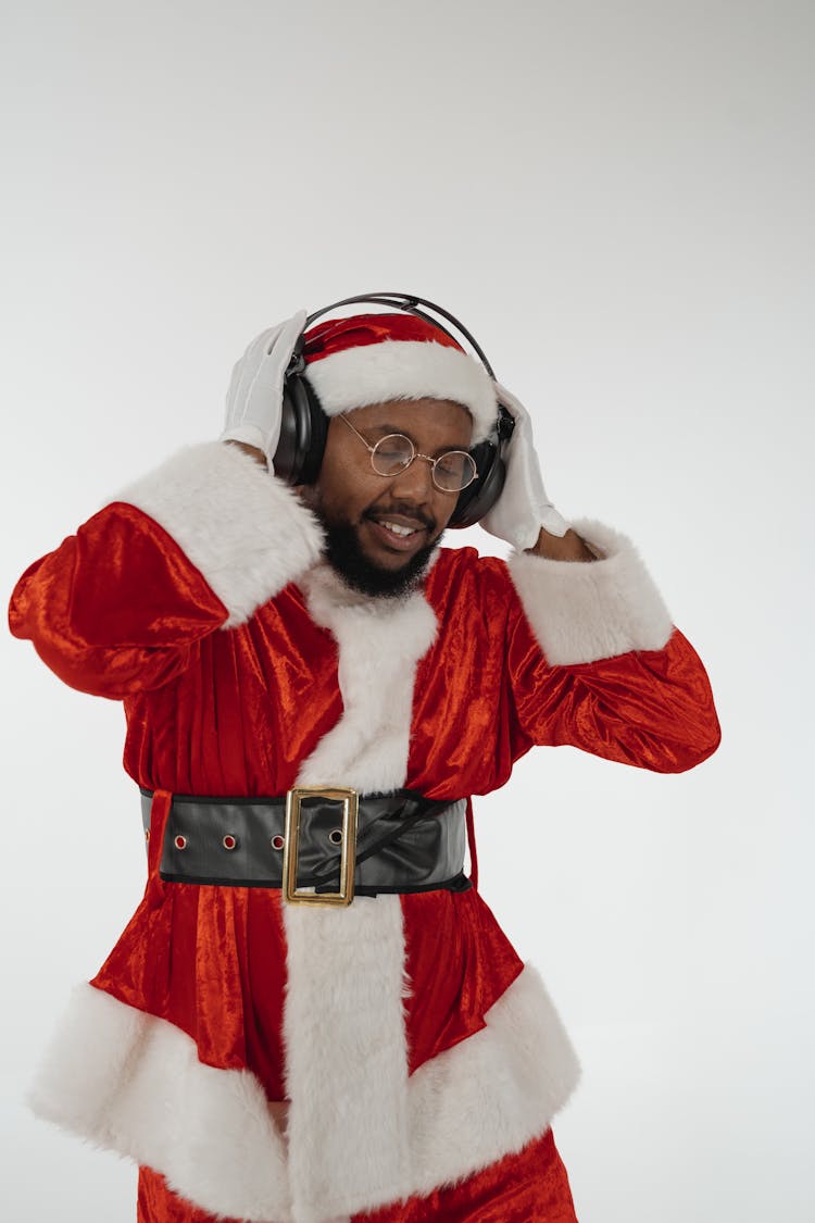 Man In Santa Claus Costume Listening To Music