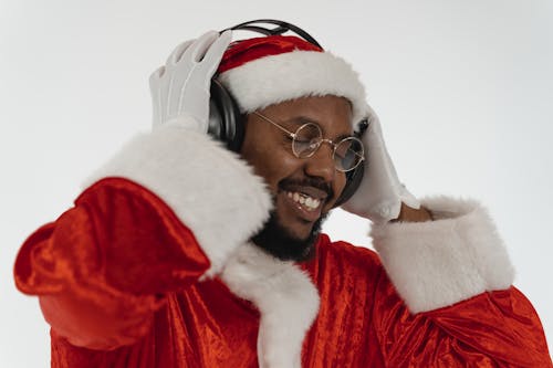 Person in Santa Claus Costume Listening to Music