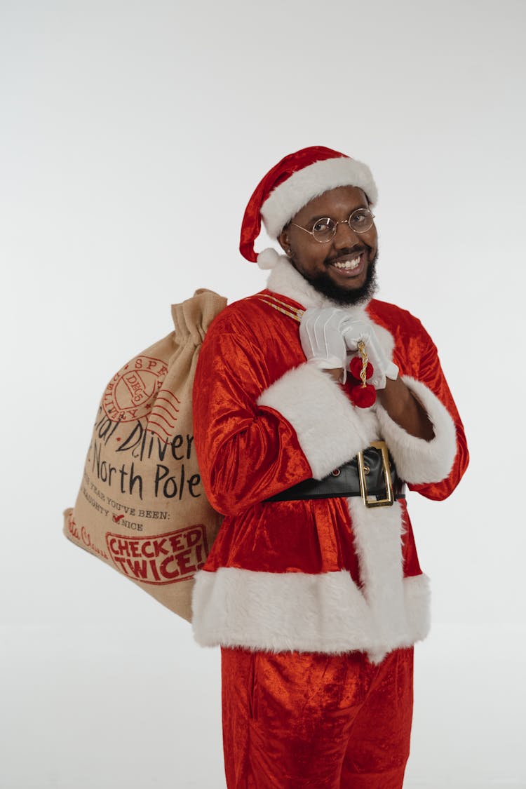 Person In Santa Claus Costume Carrying A Sack