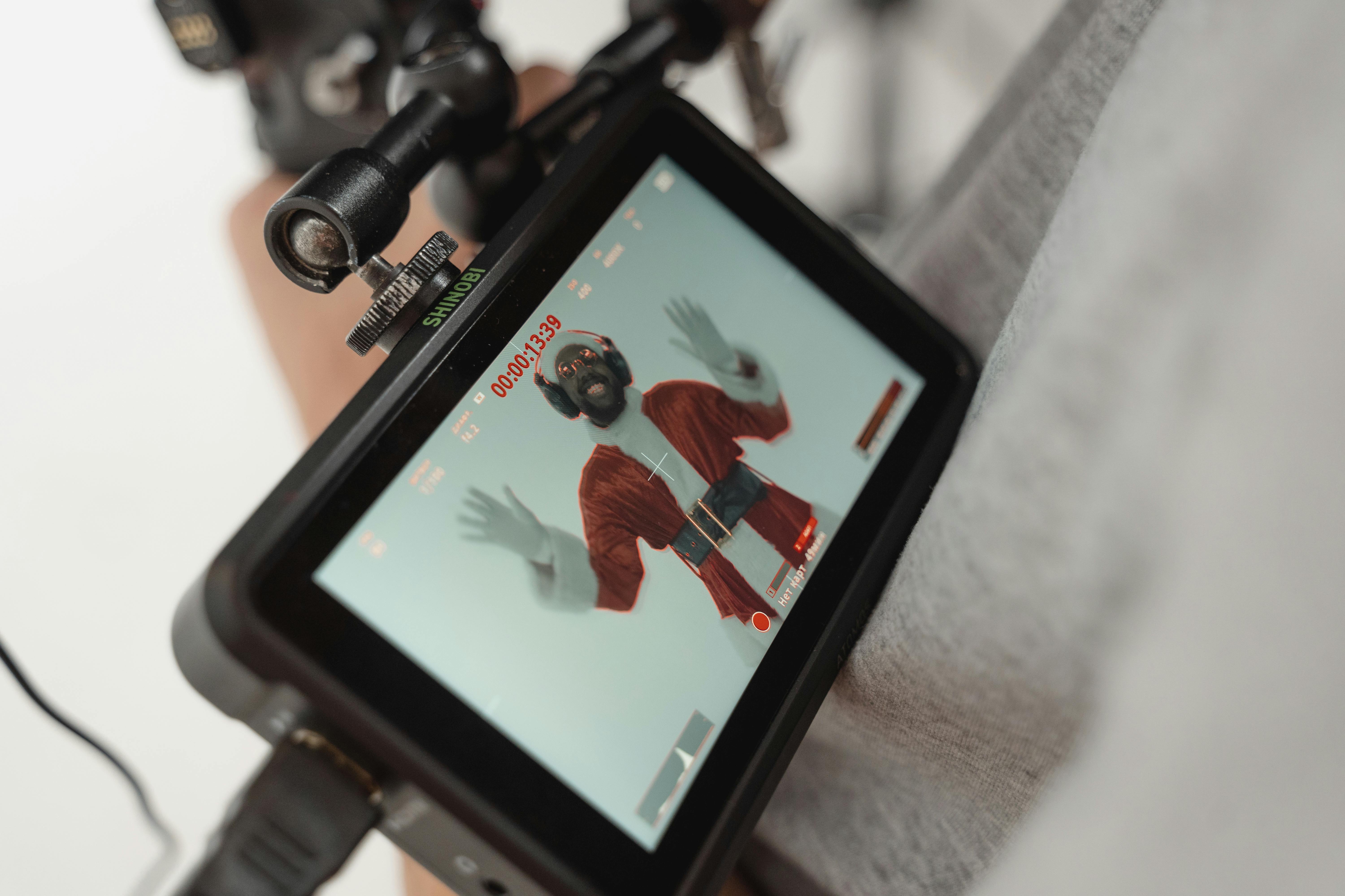 A person wearing a Santa Claus costume being recorded