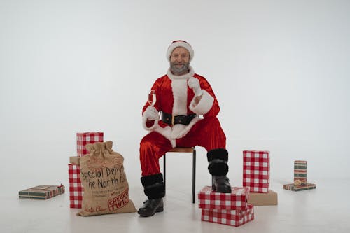 Man in Santa Claus Costume Holding a Champagne Glass