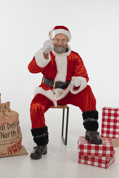 Man in Santa Claus Costume Holding a Champagne Glass