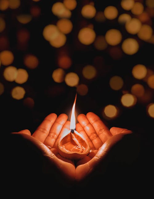 Free A Lighted Candle on a Person's Hands Stock Photo