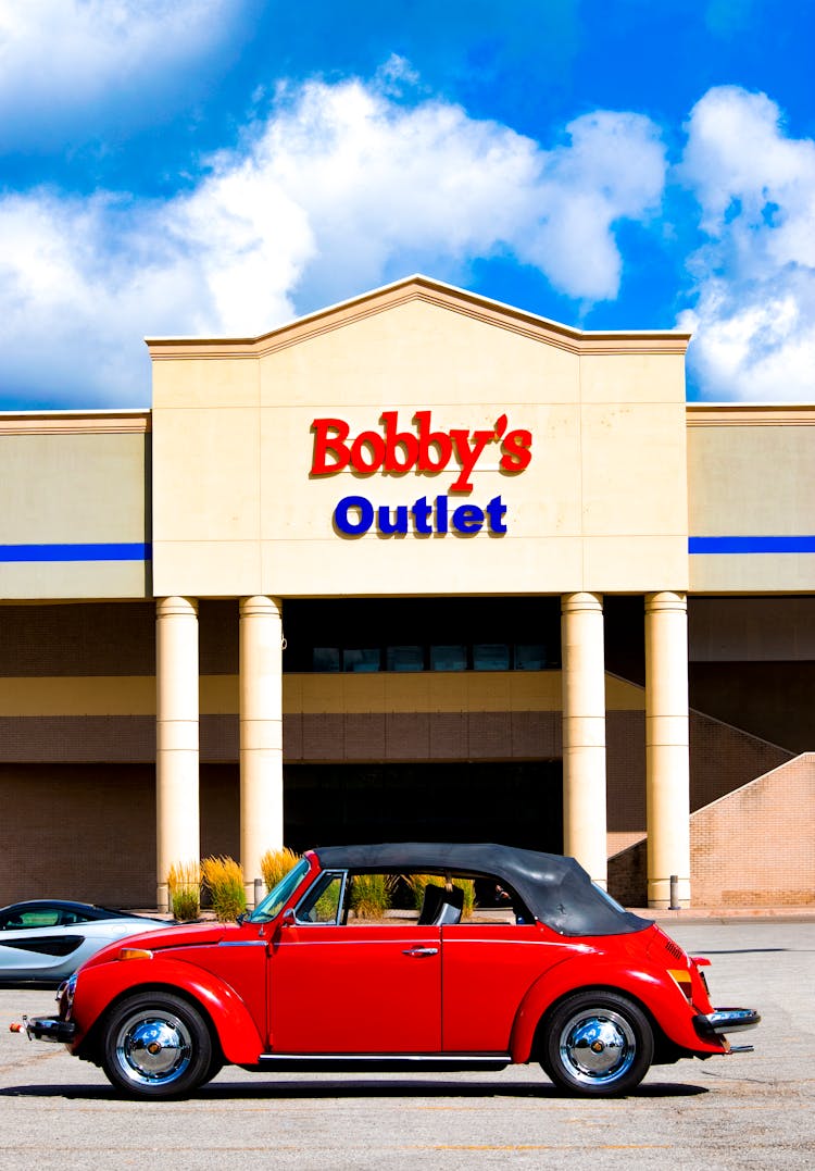 Red Convertible Car Parked In Front Commercial Establishment