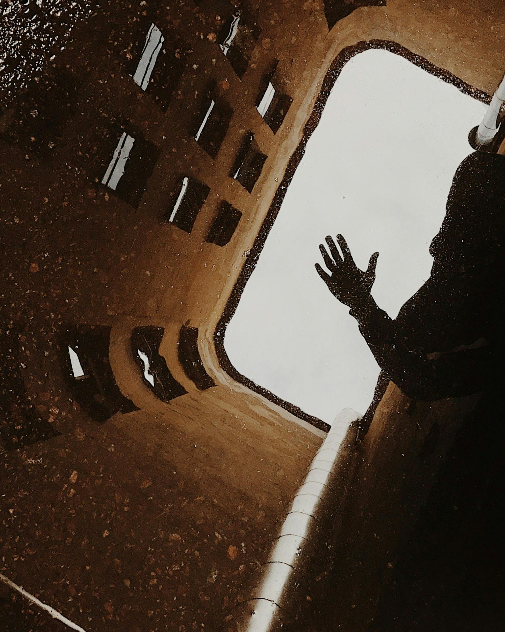 Artistic reflection of hand and architecture in rainy Saint Petersburg.