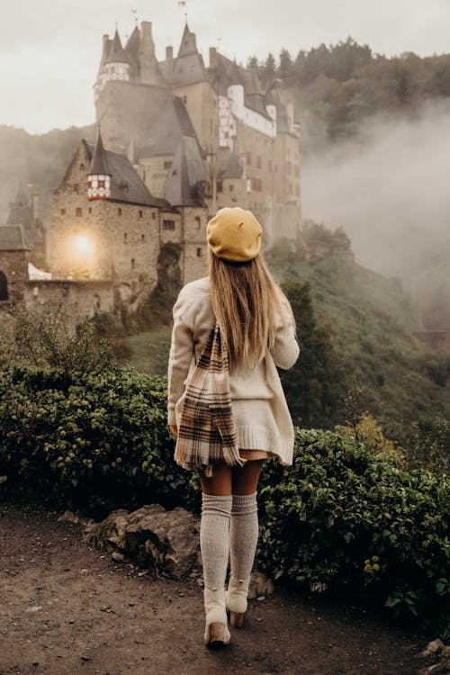 Free Woman Standing Near a Castle Stock Photo