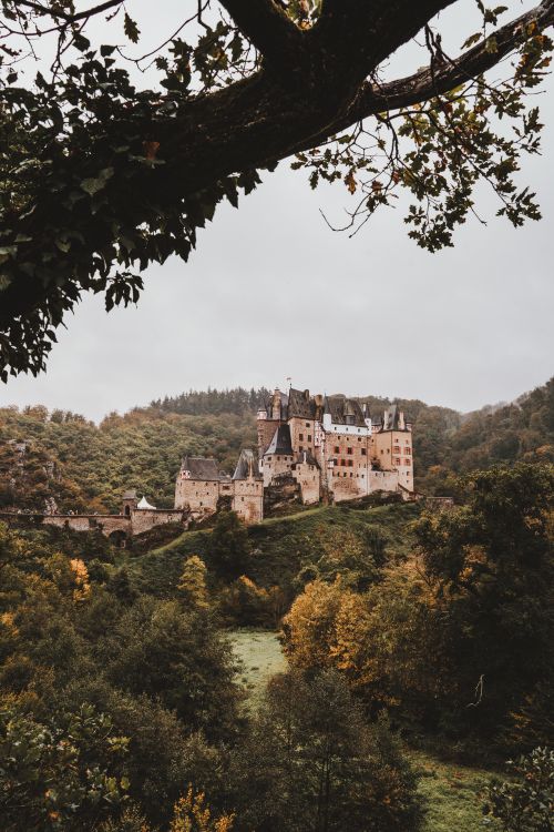 Free Explore the enchanting Eltz Castle surrounded by autumn foliage, a perfect fairytale setting in Germany. Stock Photo