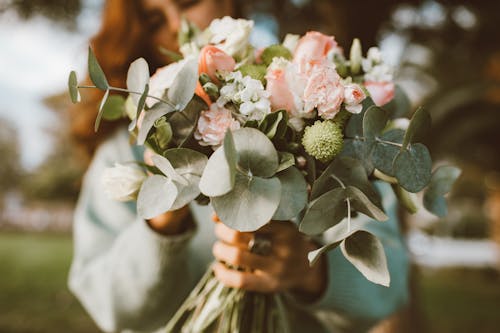 Free Close Up Shot of a Woman Holding Bouquet of Flowers Stock Photo