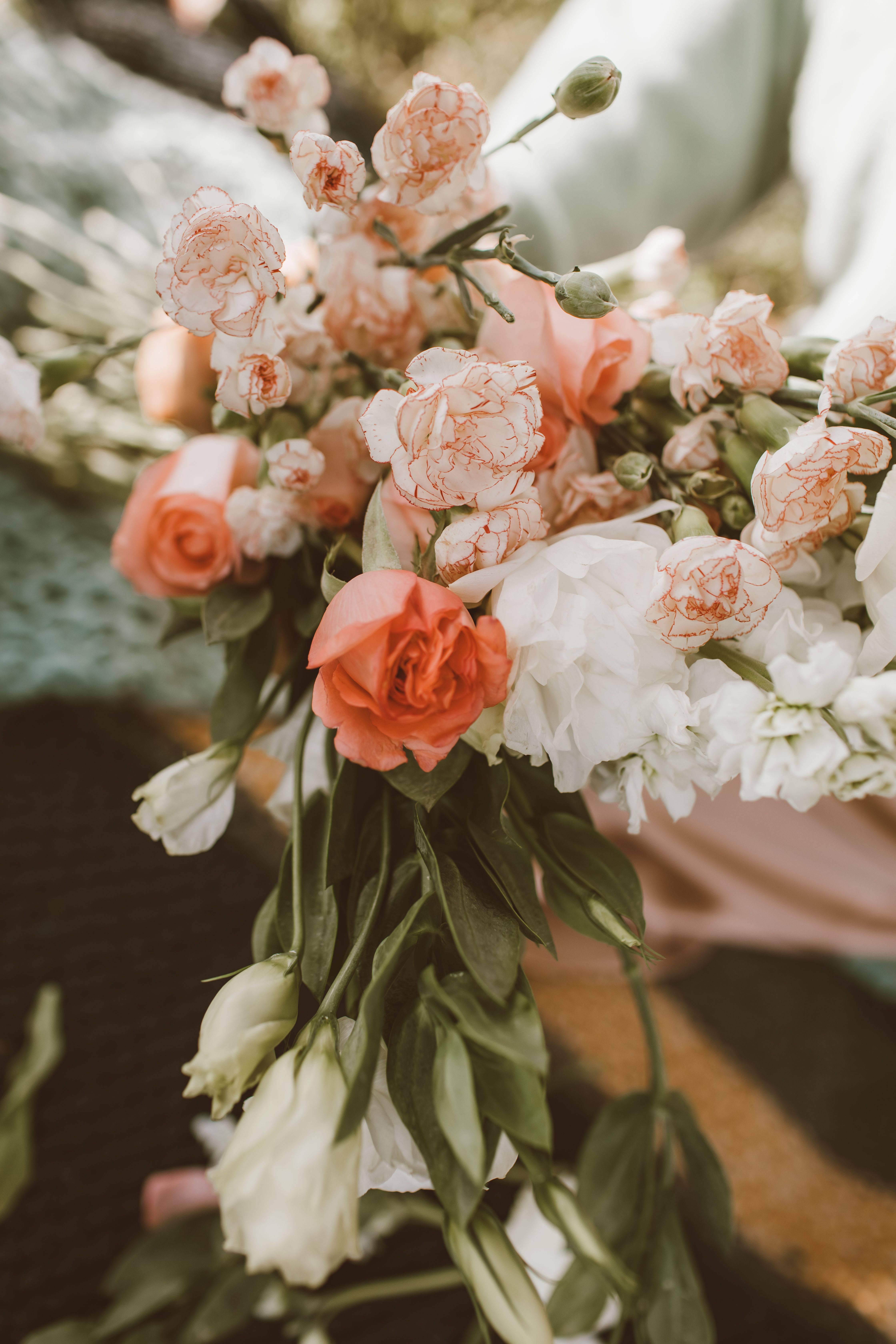 A beautiful pastel bouquet featuring roses and carnations, perfect for weddings and romantic occasions.