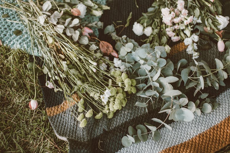 Flowers And Eucalyptus On A Blanket