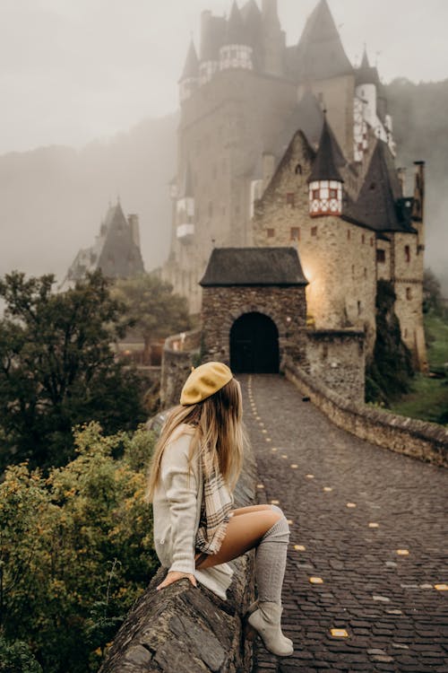 Free Stylish Woman Sitting Near a Castle Stock Photo