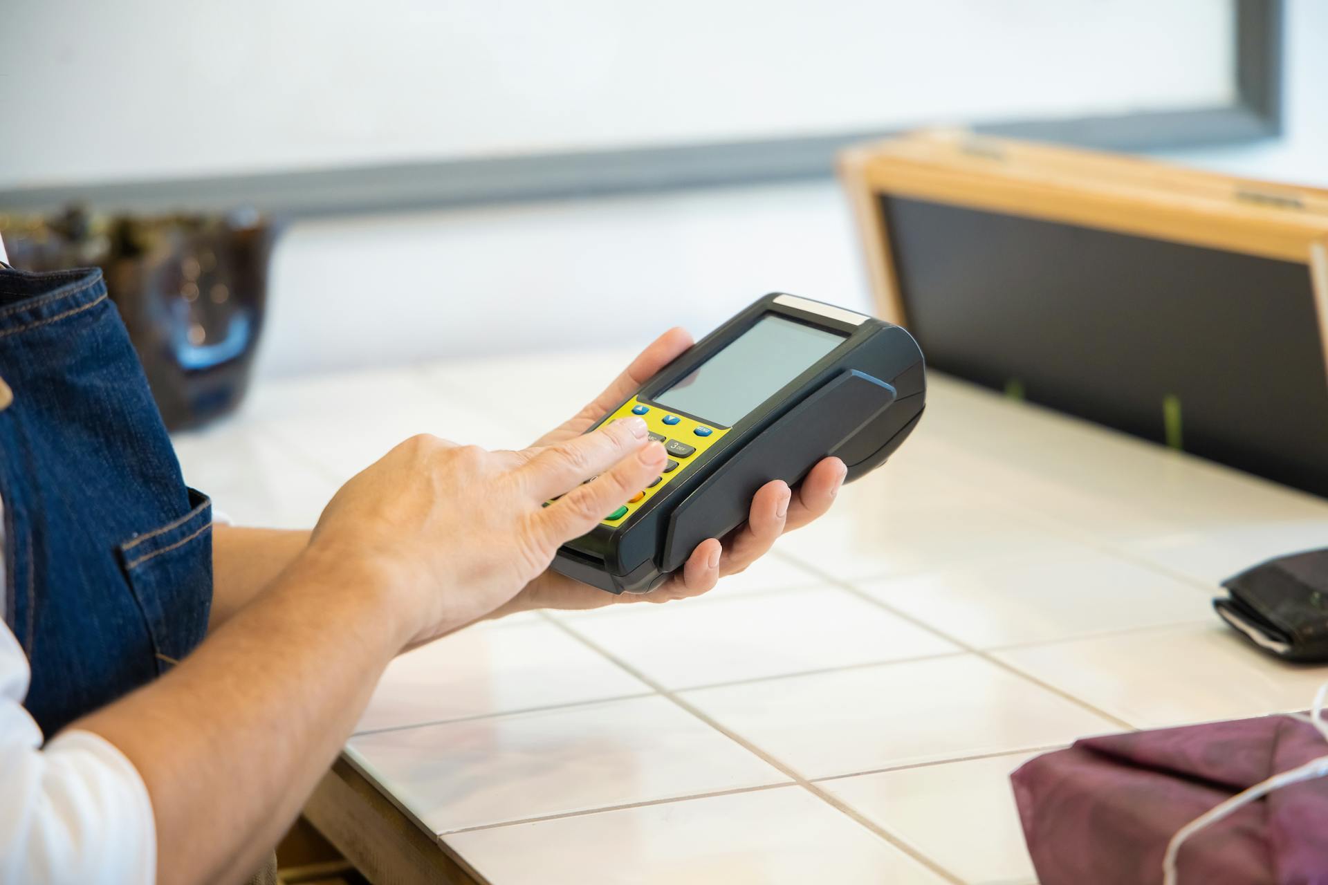 A Person Holding a POS Machine