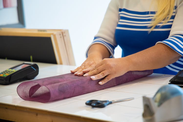 A Person Wrapping A Gift 