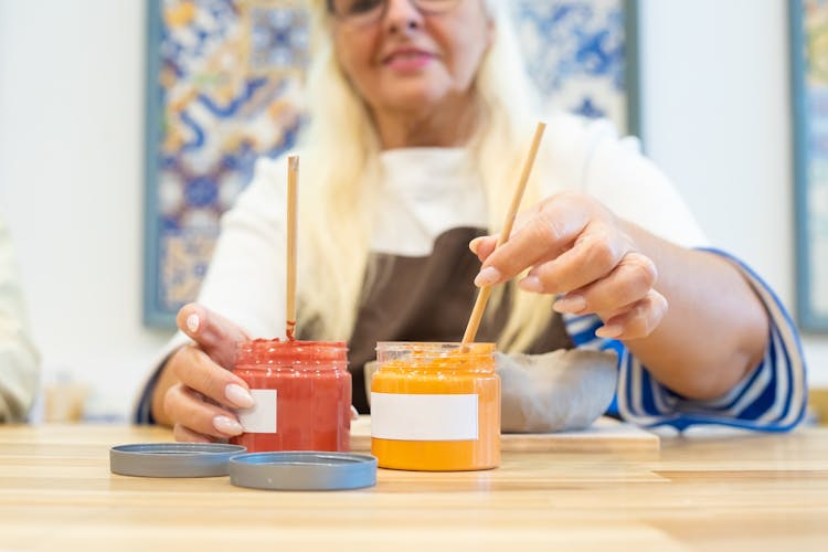 A Woman Mixing A Paint 