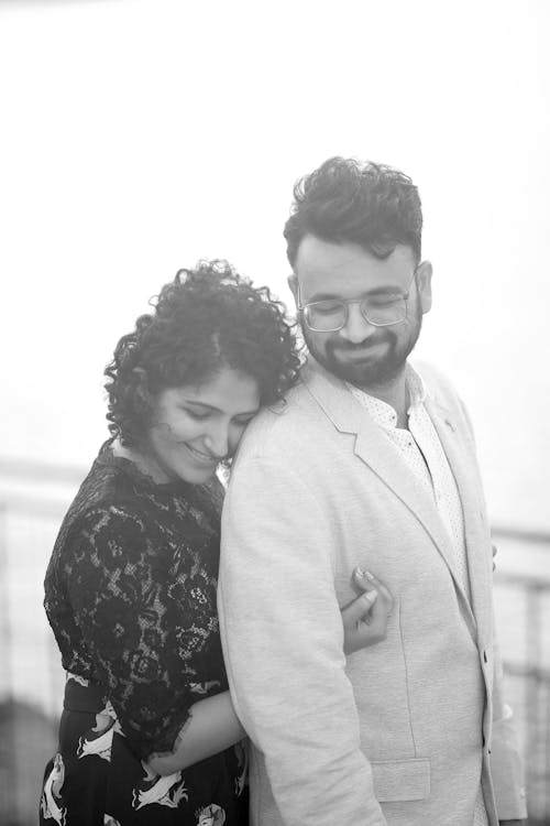 Monochrome Shot of a Woman Hugging Her Man