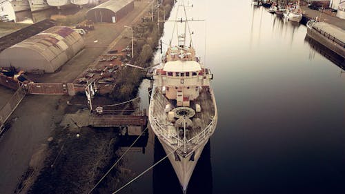 Fishing Boat Docked in Industrial Harbor