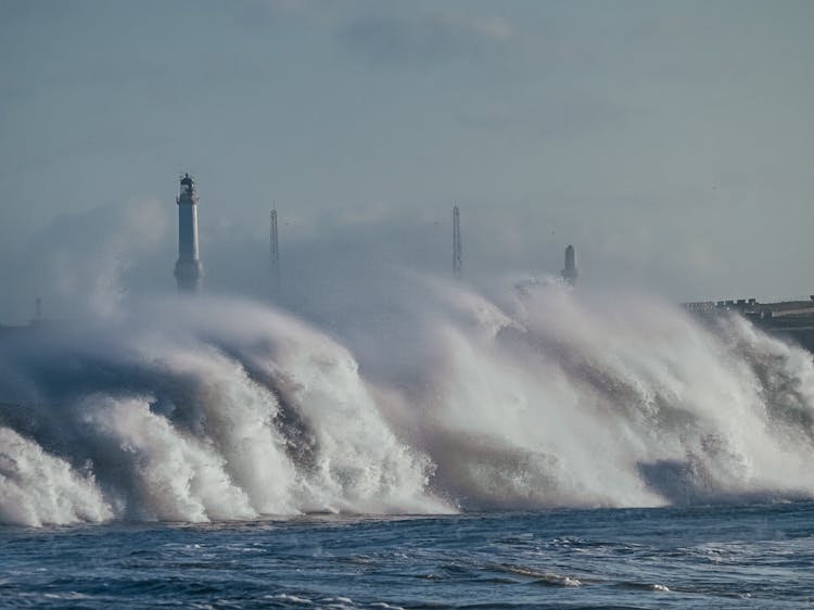 Water Splash Near A Lighthouse