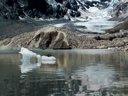 Free Serene lake with melting glacier reflecting climate change impact. Stock Photo