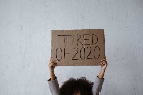 Person Holding Brown Cardboard with Print