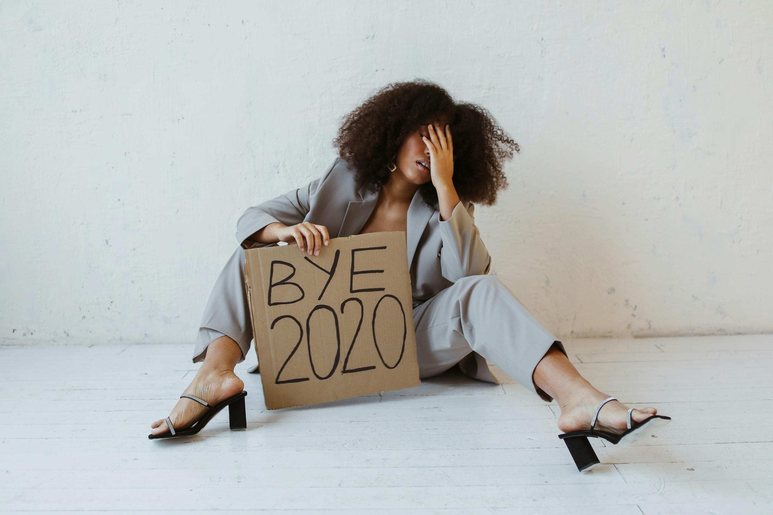 a woman holding a sign about burnout