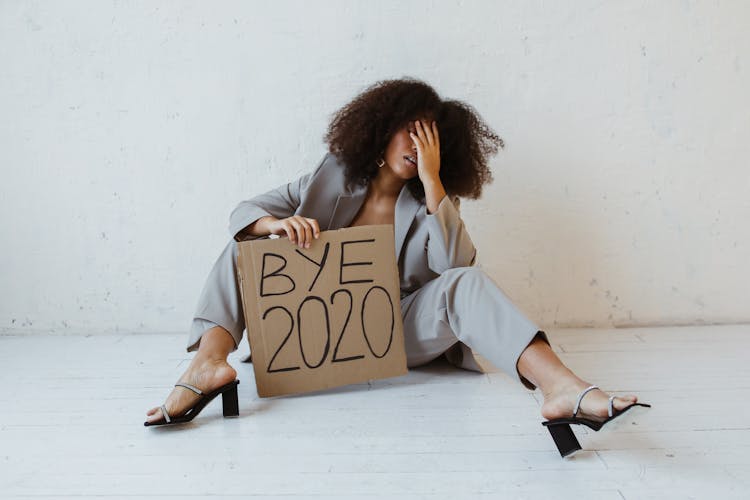 A Woman Holding A Sign About Burnout