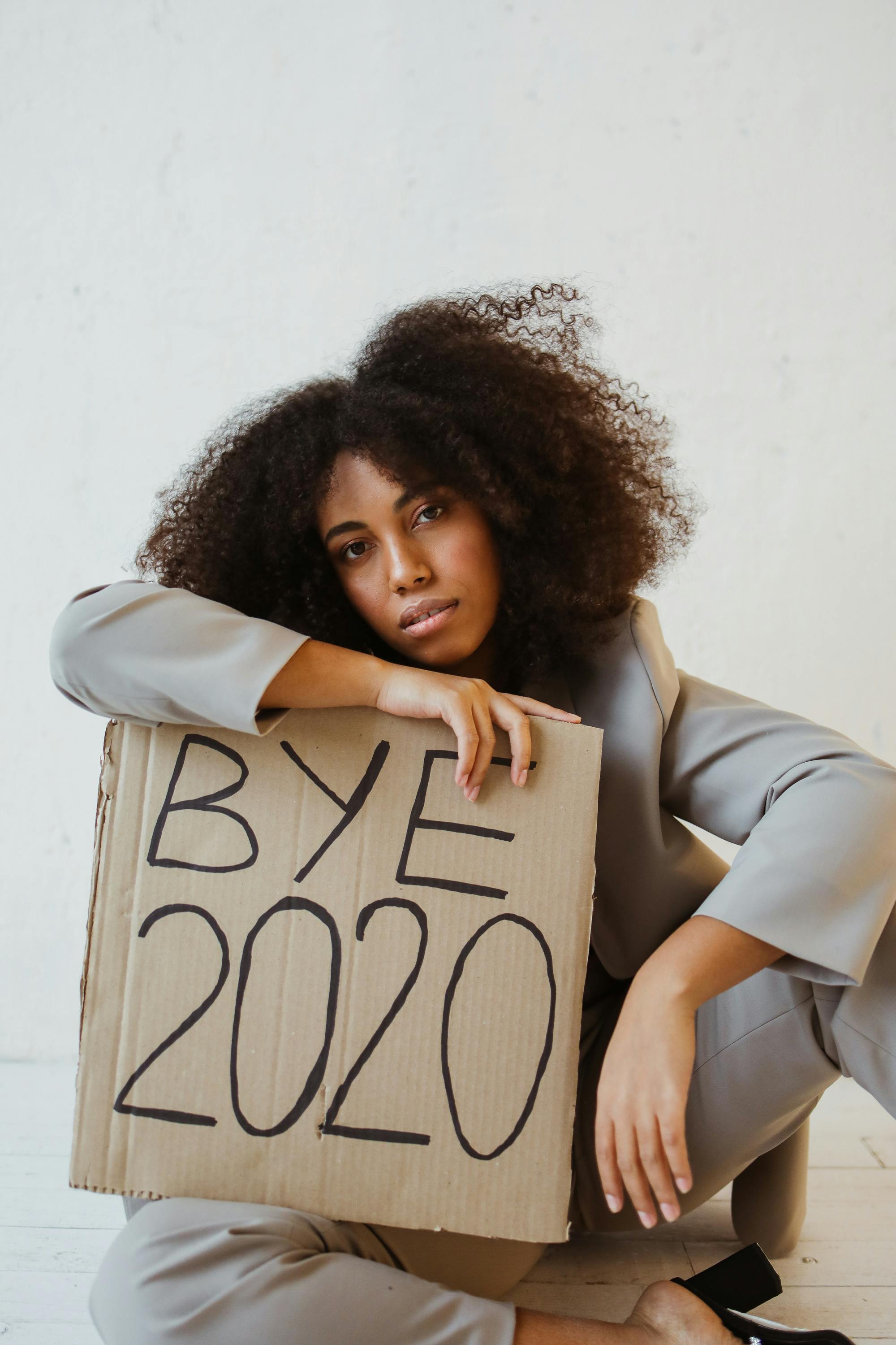 a woman holding a sign about burnout