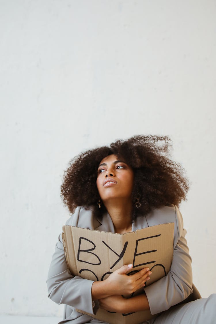 A Woman Holding A Sign About Burnout