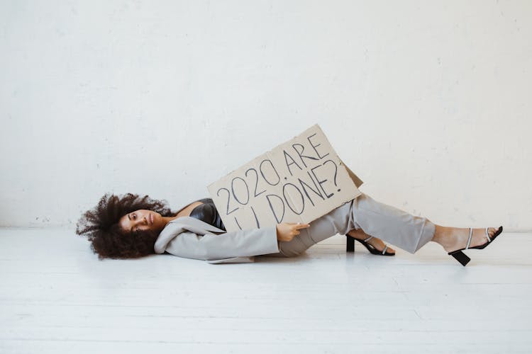 A Woman Holding A Sign About Burnout