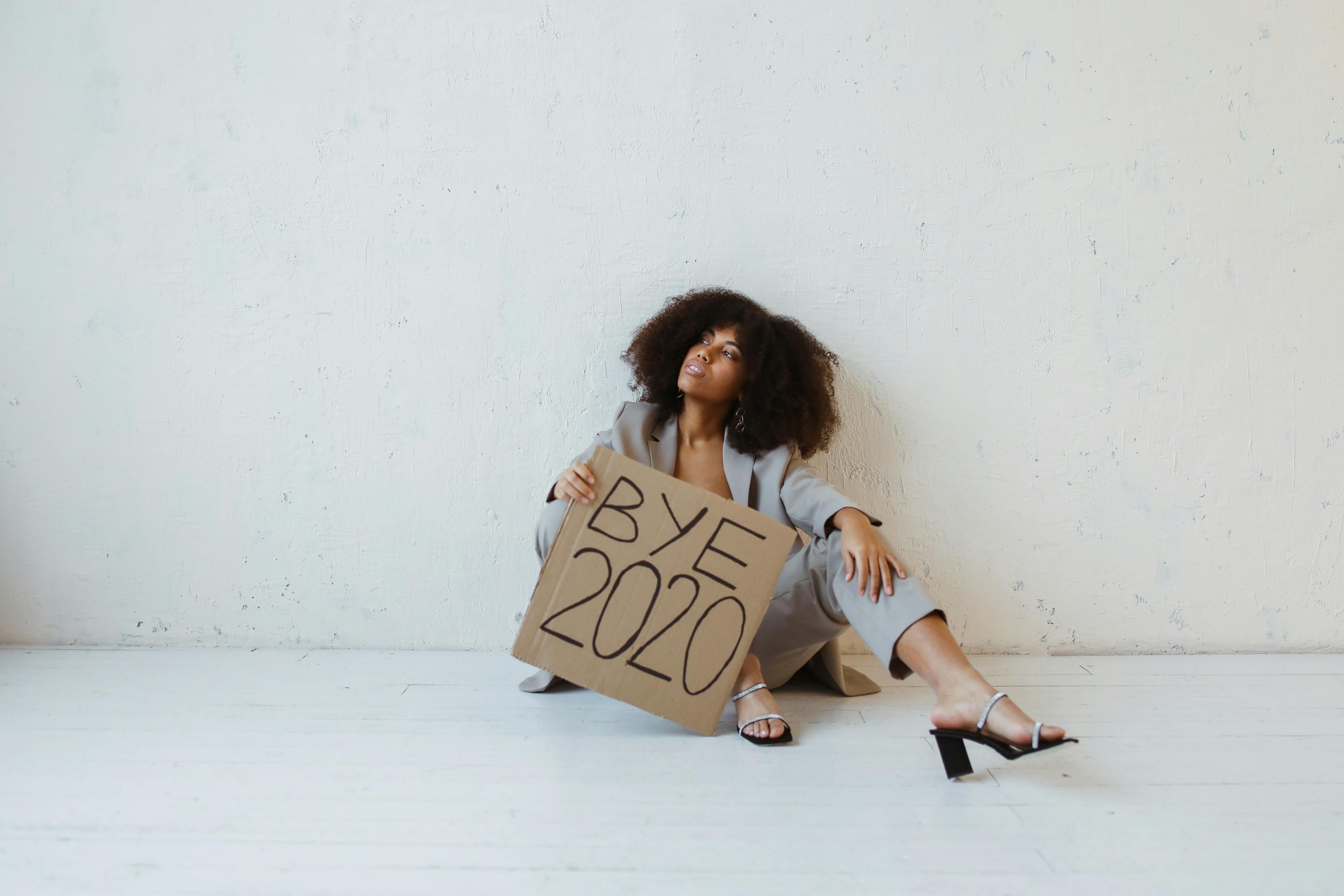 a woman holding a sign about burnout