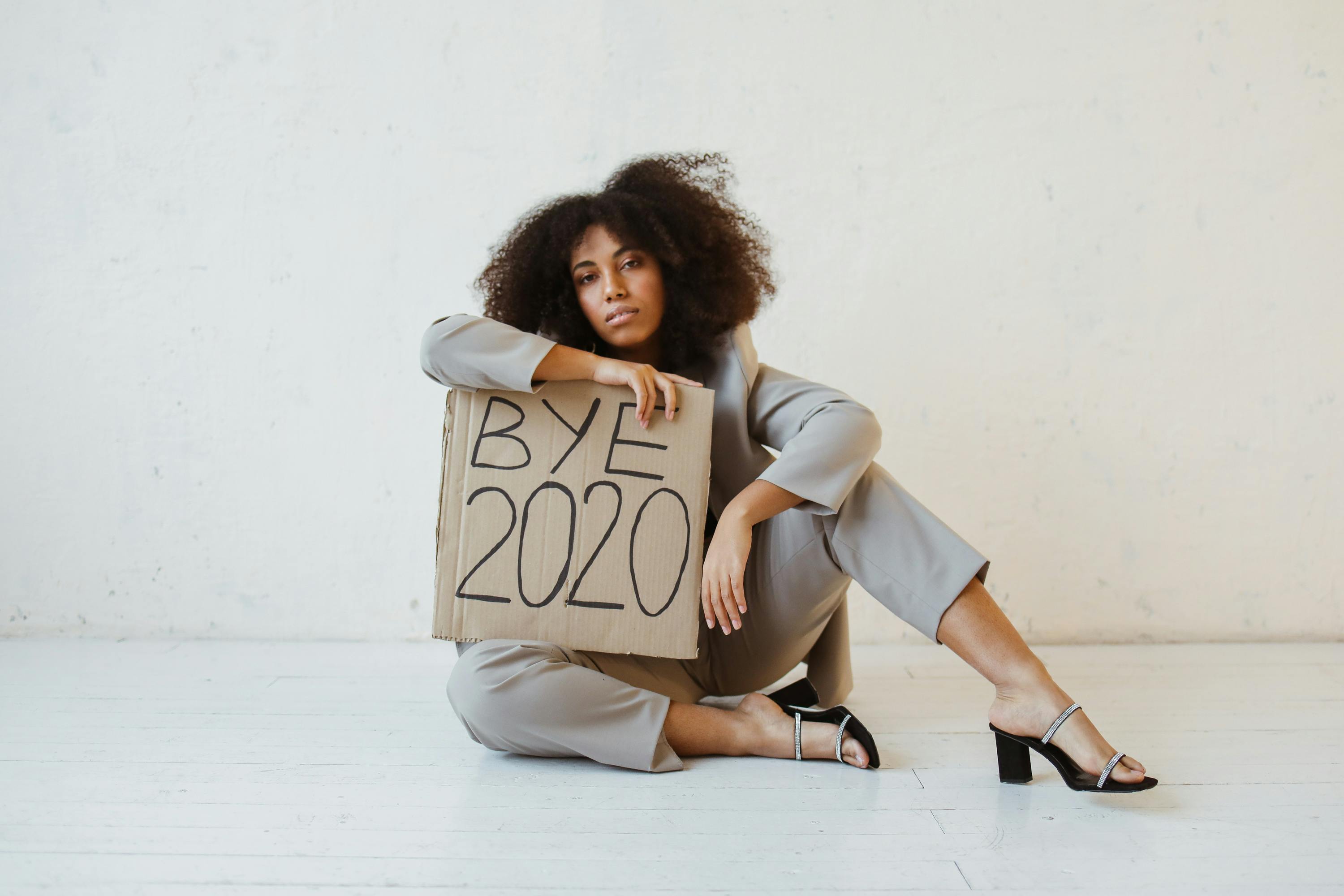 a woman holding a sign about burnout