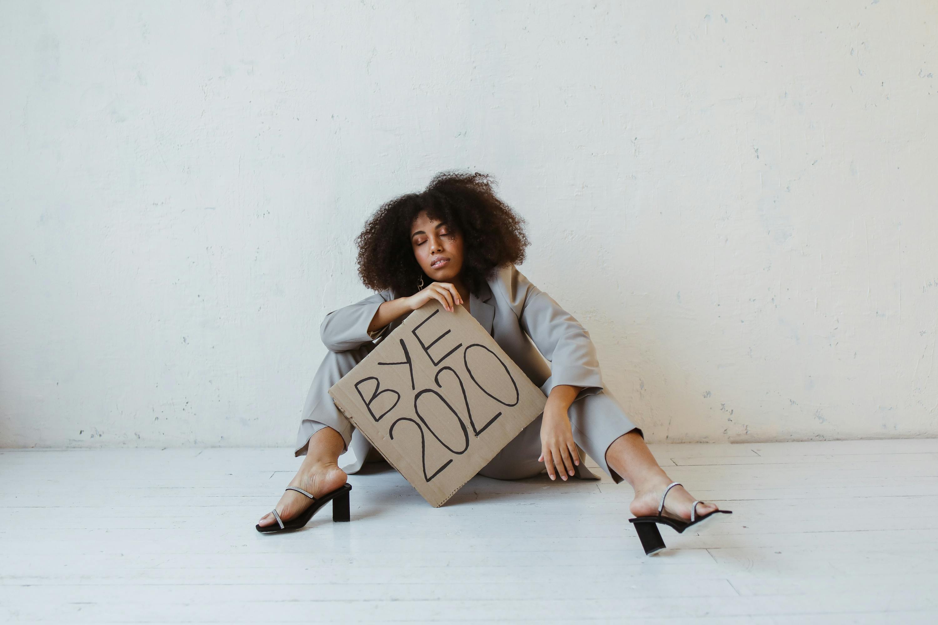 a woman holding a sign about burnout