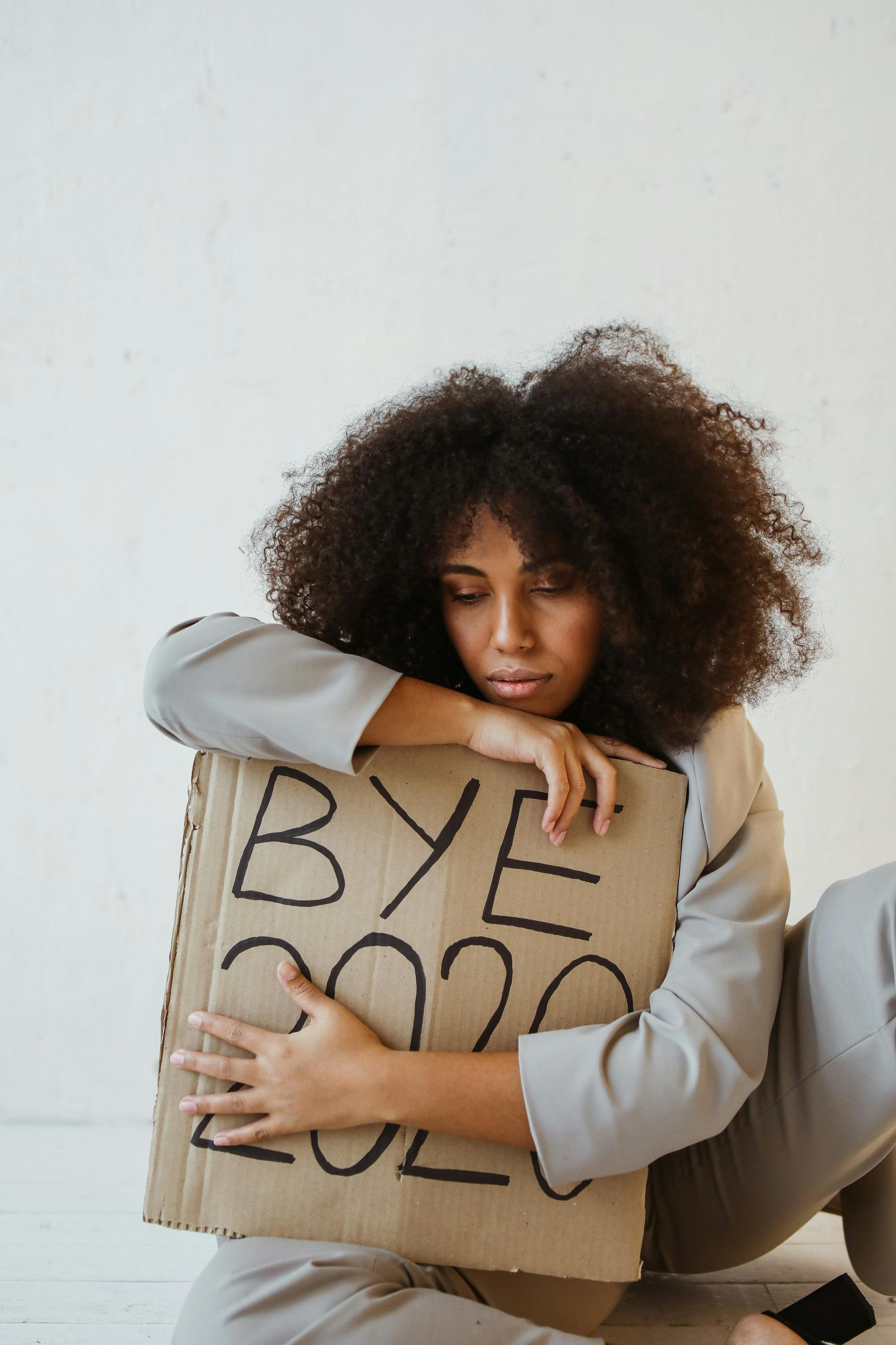a woman holding a sign about burnout
