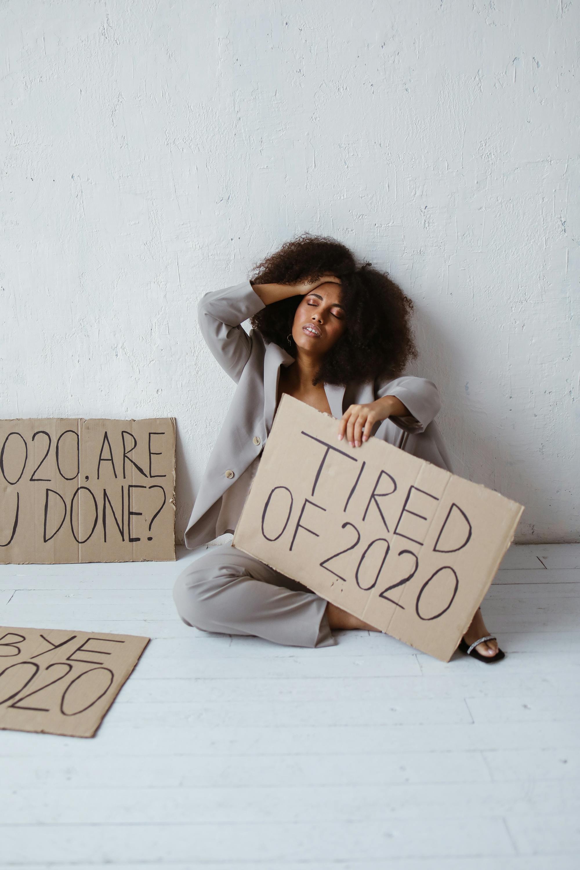 woman wearing a coat holding a placard sign