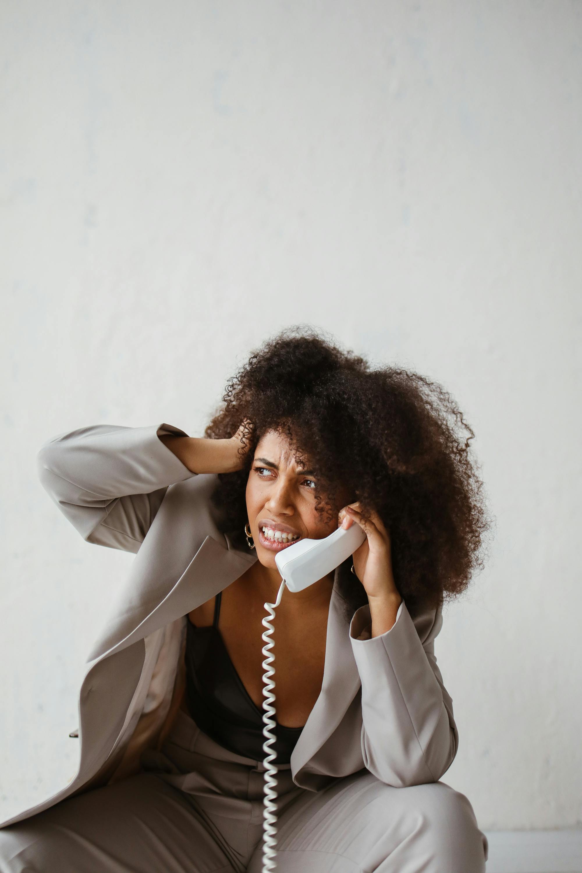 a stressed woman holding a handset