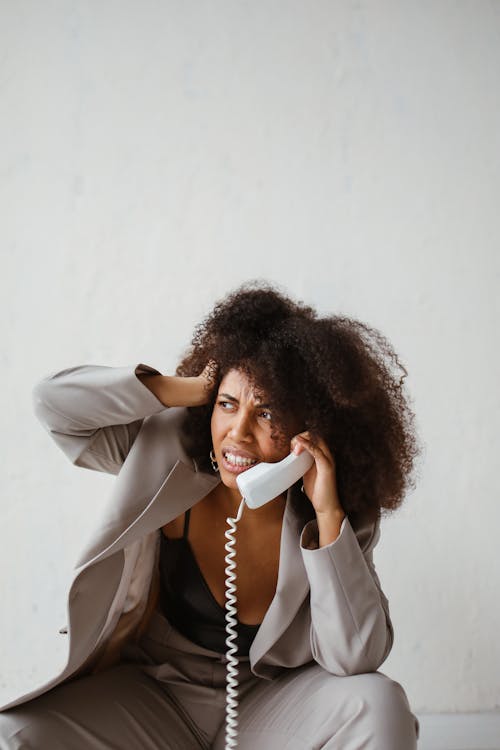 A Stressed Woman Holding a Handset