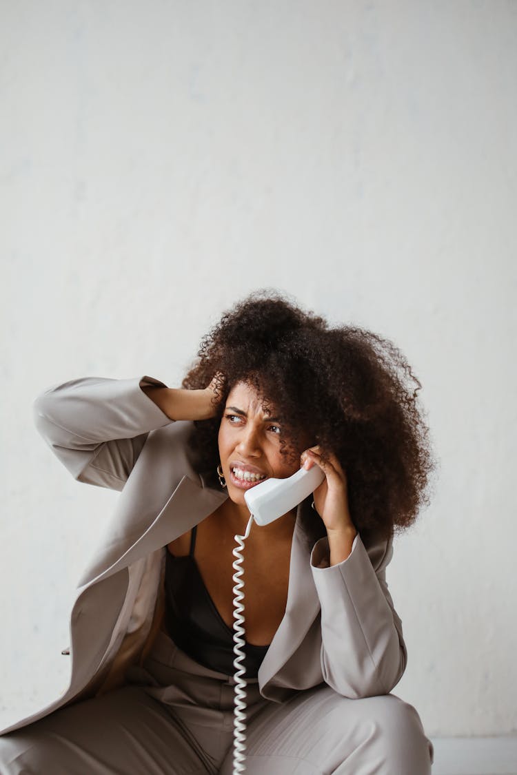 A Stressed Woman Holding A Handset