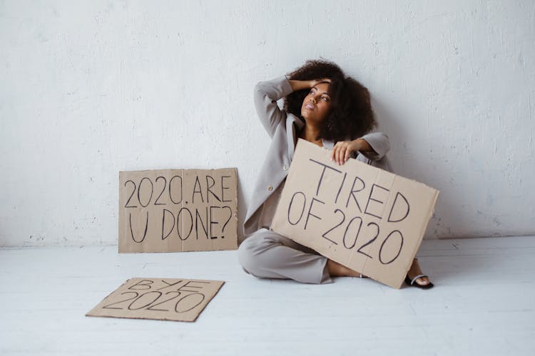 Woman Holding A Cardboard Sign