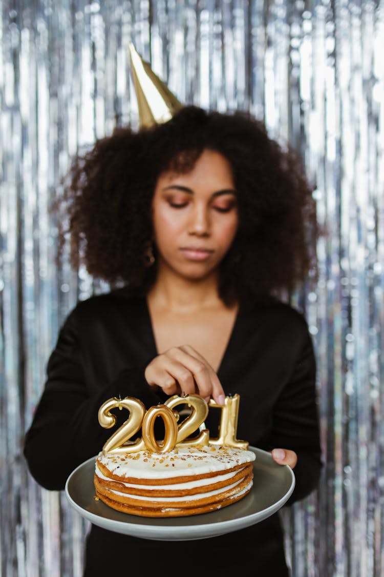 A Woman Celebrating The New Year With A Cake