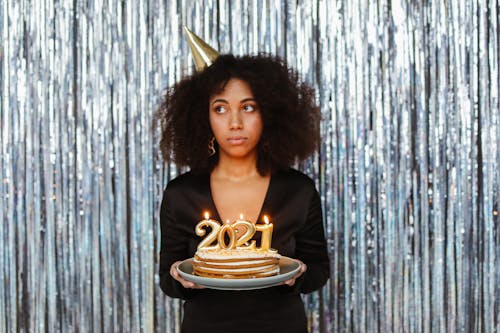 A Woman Celebrating the New Year with a Cake