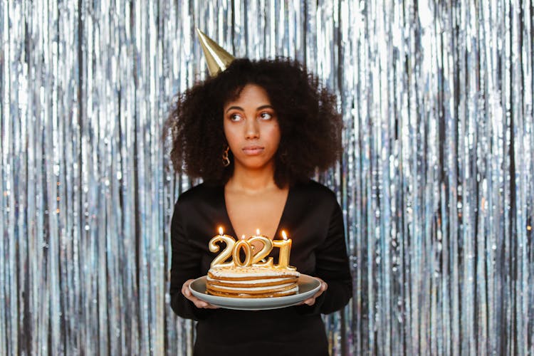 A Woman Celebrating The New Year With A Cake