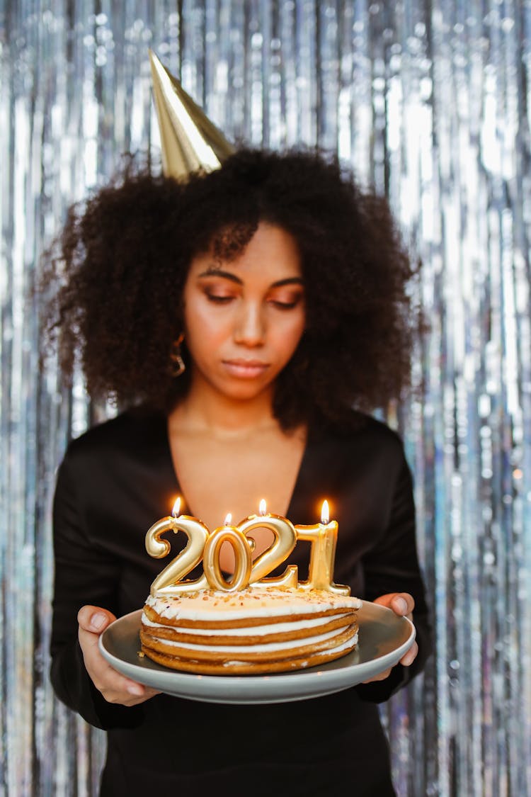 A Woman Celebrating The New Year With A Cake